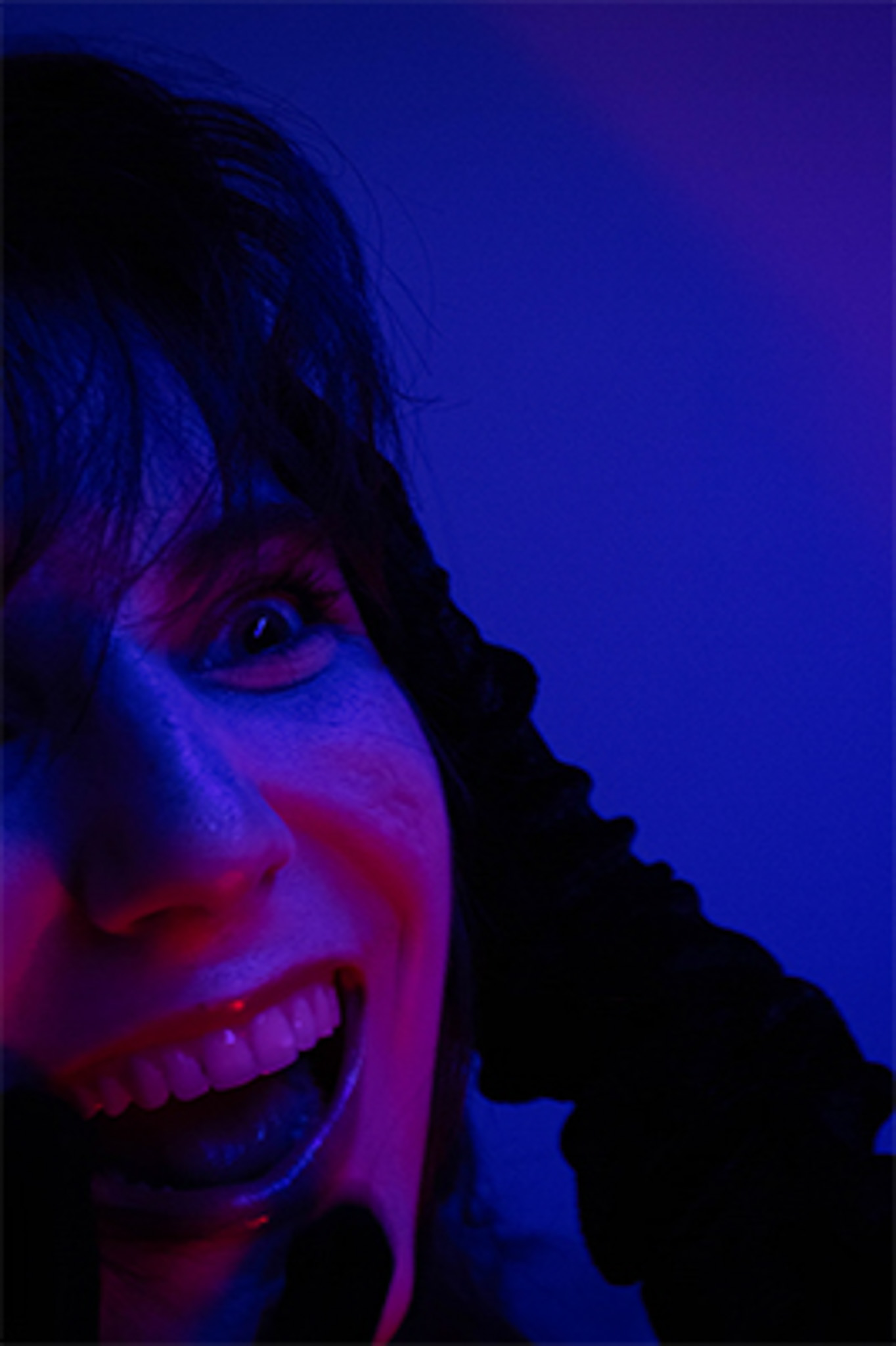 purple up-close portrait of a woman smiling crazily