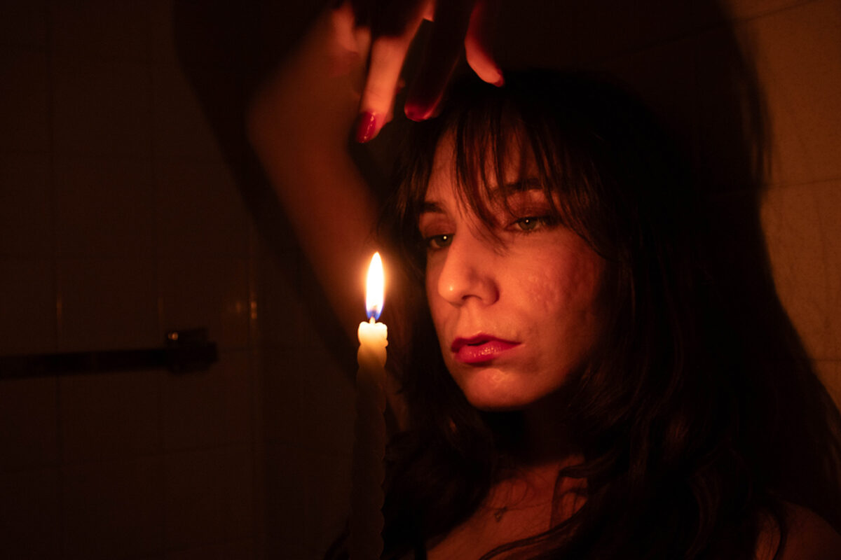 red portrait of a woman looking directly into camera crazily