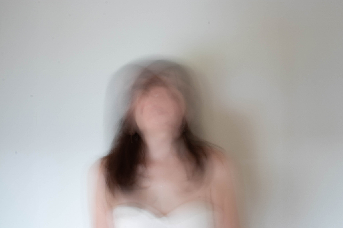 red portrait of a woman looking directly into camera crazily